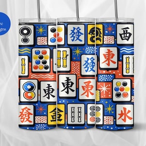 May include: Three stainless steel tumblers with a colorful Mahjong tile pattern. The design features various tiles in red, yellow, and blue on a dark blue background. The tumblers have a silver straw and the text "9 Free Designs" in a blue circle.