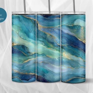 May include: Three stainless steel tumblers with a vibrant abstract design in shades of teal, blue, and gold. The tumblers have a glossy finish and include a straw. The text "9 Free Designs" is visible on the left.