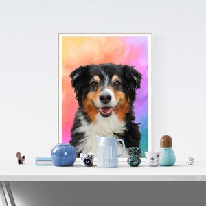 May include: A framed painting of a dog with black, brown, and white fur. The dog is smiling and has a colorful background behind it. The painting is on a white table with a variety of blue and white ceramic items.