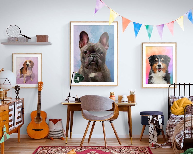 May include: Three framed watercolor paintings of dogs. The paintings are hung on a white wall in a room with a wooden desk, a chair, a guitar, and a bed. The paintings feature a French Bulldog, a Beagle, and an Australian Shepherd.