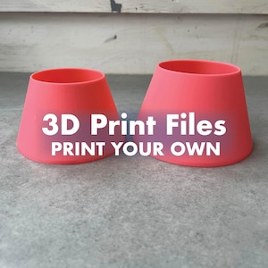 May include: Two coral-coloured, truncated cone-shaped objects with open tops and bottoms. The text "3D Print Files PRINT YOUR OWN" is overlaid in white across the centre of both objects, indicating these are digital files for 3D printing.