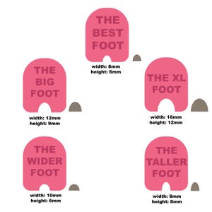 May include: Five pink foot-shaped signs with different sizes and text. The signs read "The Best Foot", "The Big Foot", "The XL Foot", "The Wider Foot", and "The Taller Foot". Each sign has a measurement in millimeters for width and height.