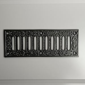 May include: Black cast iron vent cover with a decorative floral design and 10 rectangular openings.