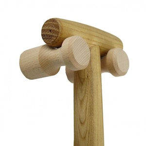May include: Wooden mallet with a T-shaped handle and two round wooden knobs on the top. The mallet is made of light brown wood.