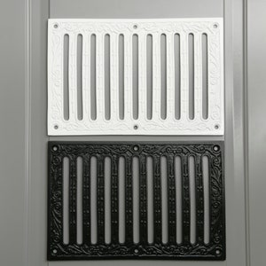 May include: Two decorative vent covers, one white and one black, with a traditional design. Both covers have a rectangular shape and feature a series of vertical bars with decorative details.