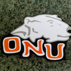 May include: A black and orange sticker with the letters "ONU" and a white polar bear head.