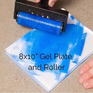 May include: An 8x10 inch gel plate and roller. The roller is blue and is being used to spread blue paint on the gel plate.