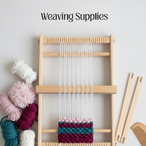 May include: A wooden weaving loom with white warp threads and a partially woven section in pink, teal, and burgundy. The image also shows various yarn balls in white, pink, teal, and burgundy, along with wooden weaving tools. The text "Weaving Supplies" is at the top.