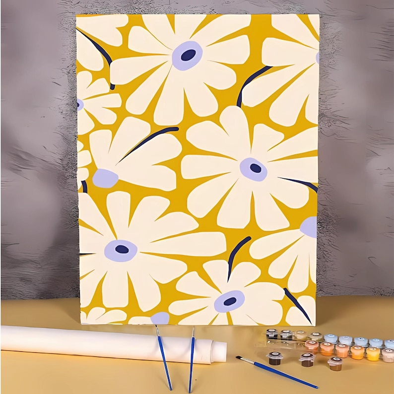 May include: A paint by numbers kit featuring a yellow background with white flowers with blue centers. The kit includes a canvas, paint brushes, and acrylic paints.