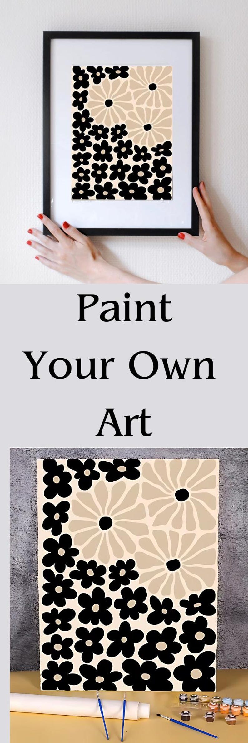 May include: Paint by numbers kit featuring a black and beige floral design. The kit includes a canvas, paintbrushes, and paint pots.