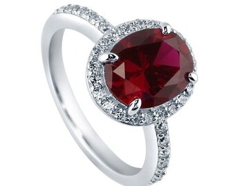 14k White Gold Engagement Ring Center Is A 2.00 ct Oval Lab Grown Ruby