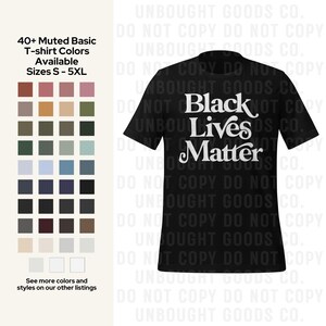 May include: Black t-shirt with the words "Black Lives Matter" in white script. The image also shows a color chart of muted t-shirt colors and the text "40+ Muted Basic T-shirt Colors Available Sizes S-5XL."