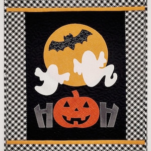 May include: A black and white checkered fabric with a black panel featuring a yellow moon with a bat, two white ghosts, a large orange pumpkin with a jack-o-lantern face, and the word "HOH" in gray.