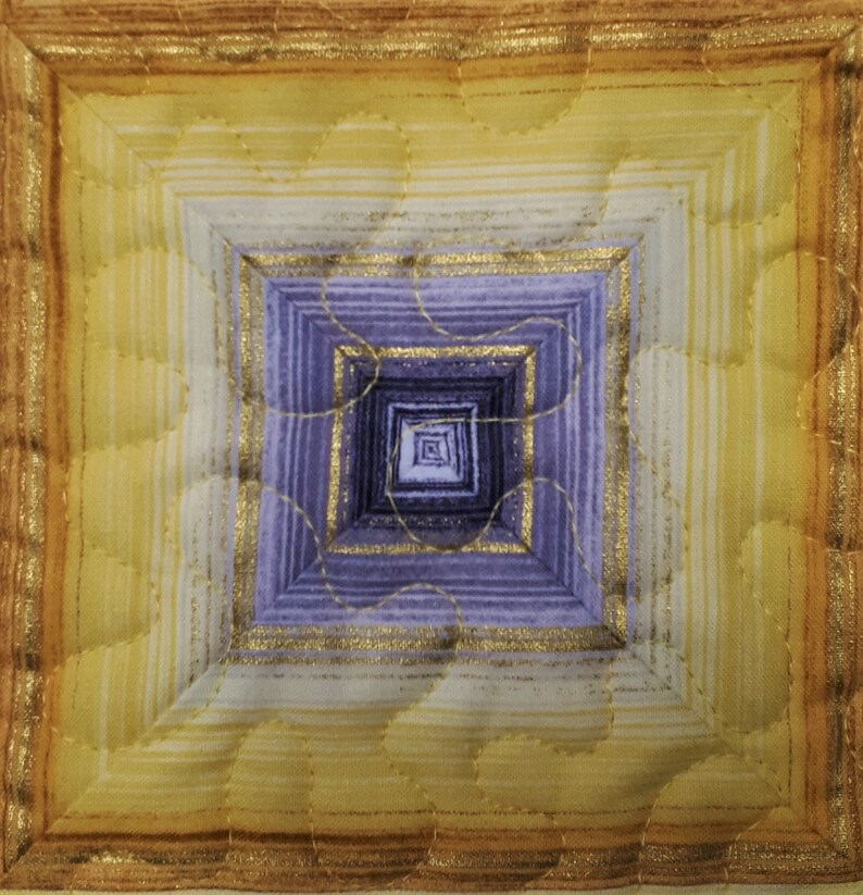 May include: A square quilted wall hanging with a concentric pattern of squares in shades of purple, yellow, and gold. The center of the piece is a small square with a subtle pattern.