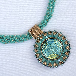 May include: A teal and gold beaded necklace with a round pendant featuring a teal and gold iridescent design.
