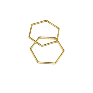 May include: Two gold hexagon rings stacked on top of each other.