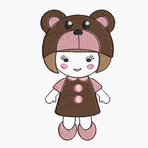 May include: A brown and pink doll wearing a brown bear hat with pink ears and a brown dress with pink buttons. The doll has brown hair, pink cheeks, and a smiling face.