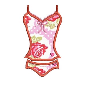 May include: A pink and red floral print swimsuit with a red bow on the top and a heart on the bottom. The swimsuit has a white polka dot pattern.