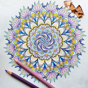 May include: A colorful mandala design with intricate patterns in shades of blue, purple, yellow, and white. The mandala is surrounded by a white background.