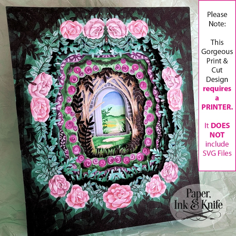 May include: A layered paper art piece featuring a garden scene with pink roses and green foliage. The artwork has a three-dimensional effect, with a view of a path and archway. Text on the side reads "Please Note: This Gorgeous Print & Cut Design requires a PRINTER."