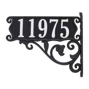 May include: Black metal house number plaque with a scrolled design. The plaque displays the number 11975 in white.