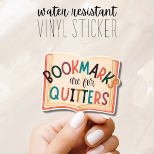 May include: Water-resistant vinyl sticker of an open book with the text "Bookmarks are for Quitters" in colorful letters.