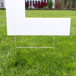 close up of plastic letter with yard stakes