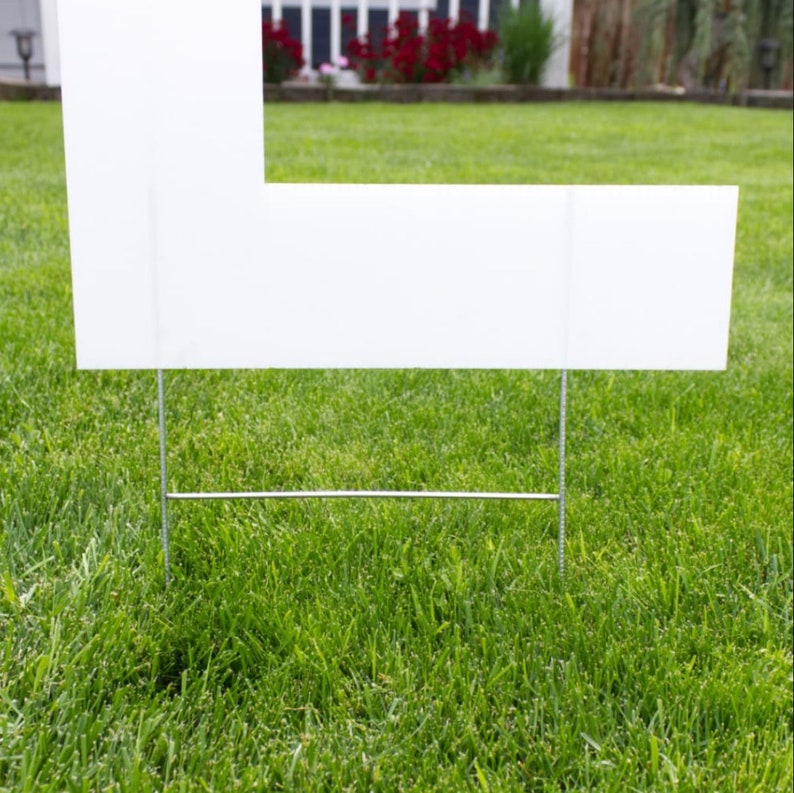 close up of plastic letter with yard stakes