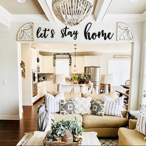 trendy living room with word sign lets stay home