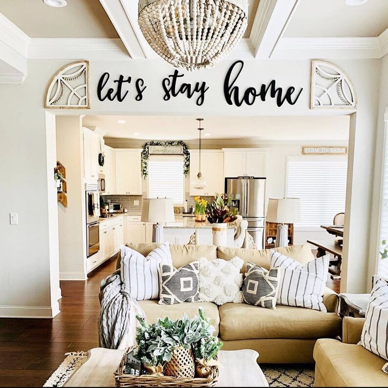 trendy living room with word sign lets stay home