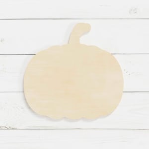 May include: A plain wooden pumpkin cutout, perfect for crafting and decorating. The pumpkin is unpainted and ready to be customized.