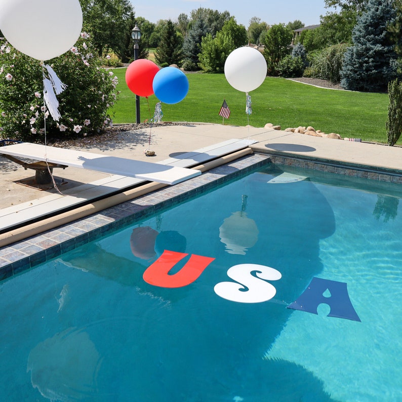 corrougated plastic coroplast letters USA floating in pool