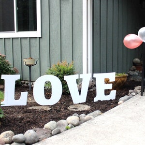 thin plastic yard sign letters spelling the word love