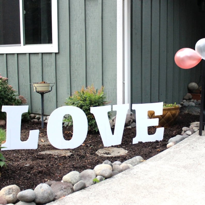 thin plastic yard sign letters spelling the word love
