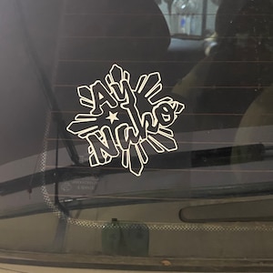 A white vinyl decal on a black car window with the Filipino flag star design and the words 'Ay Nako' in a stylized font.