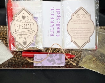 May include: A collection of items for a candle spell, including a red crayon, small packets, and a card with the text "R.E.S.P.E.C.T. Candle Spell." The items are arranged on a textured, metallic tray, with a black background.