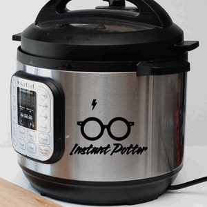 May include: A stainless steel Instant Pot with a black sticker that says "Instant Potter" and features a lightning bolt and Harry Potter's glasses.