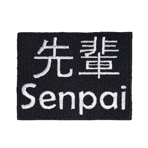 May include: Black embroidered patch with white text. The text reads "Senpai" and the Japanese characters for "Senpai".