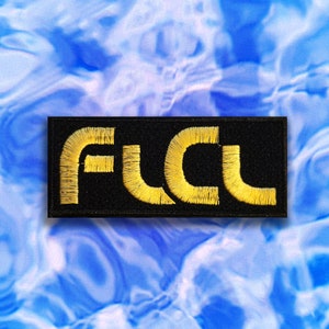 May include: Black patch with the word "F.U.C.L." embroidered in gold thread.