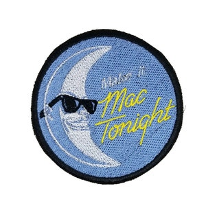 May include: A blue and white embroidered patch with a crescent moon wearing sunglasses and the text "Make it Mac Tonight".