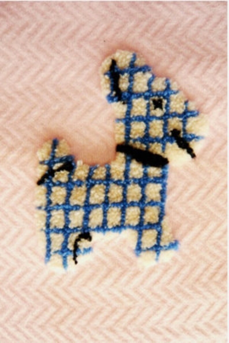 May include: A tufted dog design in blue and cream, with a black collar and accents, is set against a pink herringbone background. The dog's body is a grid pattern, creating a textured, handcrafted appearance. The overall aesthetic is soft and playful.