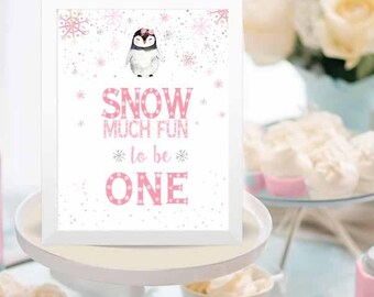 May include: A white sign with a pink penguin and snowflakes. The sign says "Snow much fun to be one".
