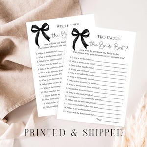 May include: Two white sheets of paper with the text "WHO KNOWS the Bride Best?" are displayed. Each sheet has a black bow graphic at the top. The text "PRINTED & SHIPPED" is at the bottom. The sheets are on a beige fabric.