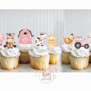 May include: Pink and brown farm animal cupcake toppers, including a pig, horse, cow, chick, chicken, tractor, and sheep. The toppers are on white cupcakes.