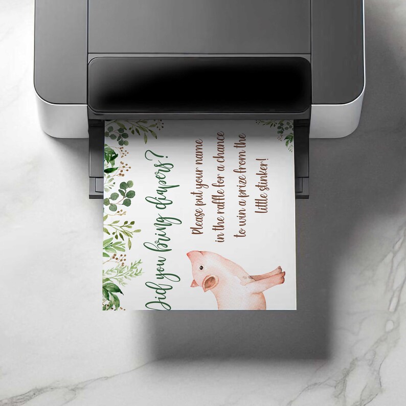 May include: A printable sign with a green and brown floral design and a pink pig illustration. The sign says "Did you bring diapers? Please put your name in the raffle for a chance to win a prize from the little stinker!"