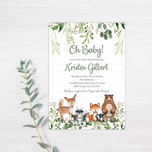 May include: A green and white baby shower invitation with a woodland theme. The invitation features a deer, fox, raccoon, owl, and bear surrounded by greenery. The text reads "Oh Baby!" and "Join us for a Baby Shower honoring Kristen Gilbert".