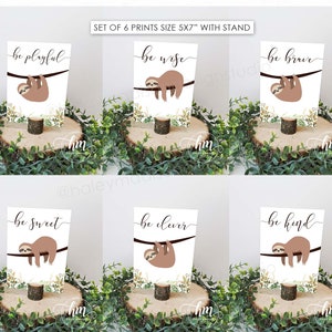 May include: Set of six 5x7 inch sloth prints with wooden stands. Each print features a sloth hanging from a branch with a motivational message: be playful, be wise, be brave, be sweet, be clever, be kind.