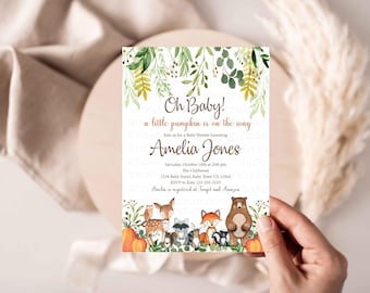 May include: Baby shower invitation with the text "Oh Baby! a little pumpkin is on the way" and the name Amelia Jones. The invitation features watercolor illustrations of woodland animals and pumpkins, with green foliage accents.