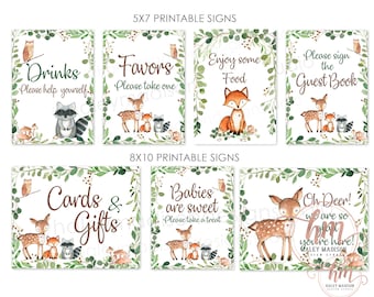 May include: Printable signs for a woodland themed baby shower. The signs feature a deer, fox, raccoon, and owl with greenery and floral accents. The signs include text such as "Drinks", "Favors", "Enjoy some Food", "Please sign the Guest Book", "Cards & Gifts", "Babies are sweet", and "Oh Deer! We are so hm you're here!"