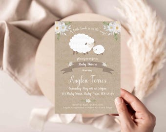 May include: A brown and white baby shower invitation with a white lamb and a smaller lamb. The invitation says "A little lamb is on the way!" and "Please join us for a Baby Shower honoring Anglea Torres".